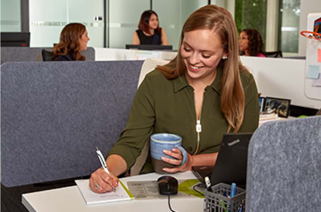 Woman working at a cubicle