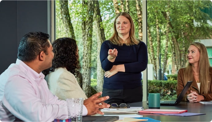 Woman talking to a group at a table