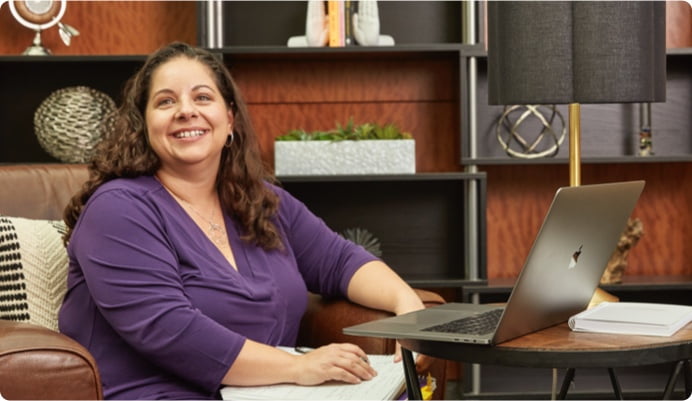 Woman at desk, smiling at the camera