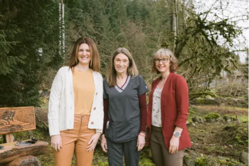 Three Corrections employees in a forest