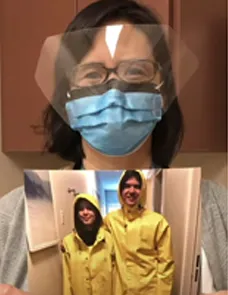 PHSA employee in protective gear holding a photo