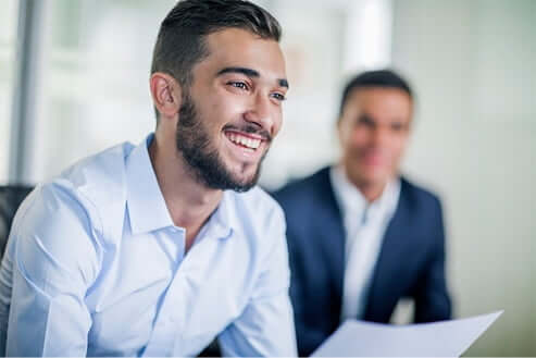 young male employee smiling during a meeting