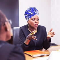 black female employee speaking during a meeting