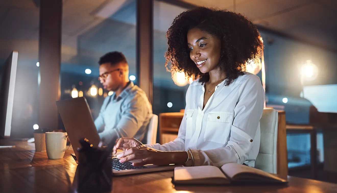 Professionals working late with laptops